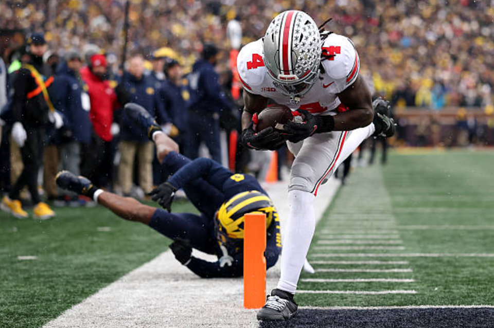 ANN ARBOR, MICHIGAN - NOVEMBER 29: Jeremiah Smith #4 of the Ohio State Buckeyes scores a touchdown against the Michigan Wolverines at Michigan Stadium on November 29, 2025 in Ann Arbor, Michigan. (Photo by Luke Hales/Getty Images)