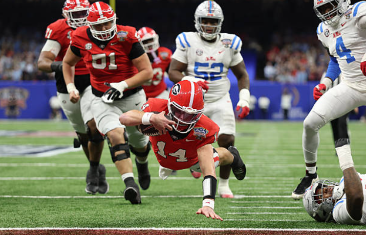 NEW ORLEANS, LOUISIANA - JANUARY 01: Gunner Stockton #14 of the Georgia Bulldogs dives for a touchdown during the second quarter against the Ole Miss Rebels during the 2025 College Football Playoff Quarterfinal at the Allstate Sugar Bowl at Caesars Superdome on January 01, 2026 in New Orleans, Louisiana. (Photo by Jamie Squire/Getty Images)